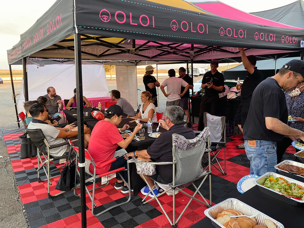 the Experience_HOSPITALITY Hospitality setup at the track with catering. Crew and clients enjoying lunch at the track.